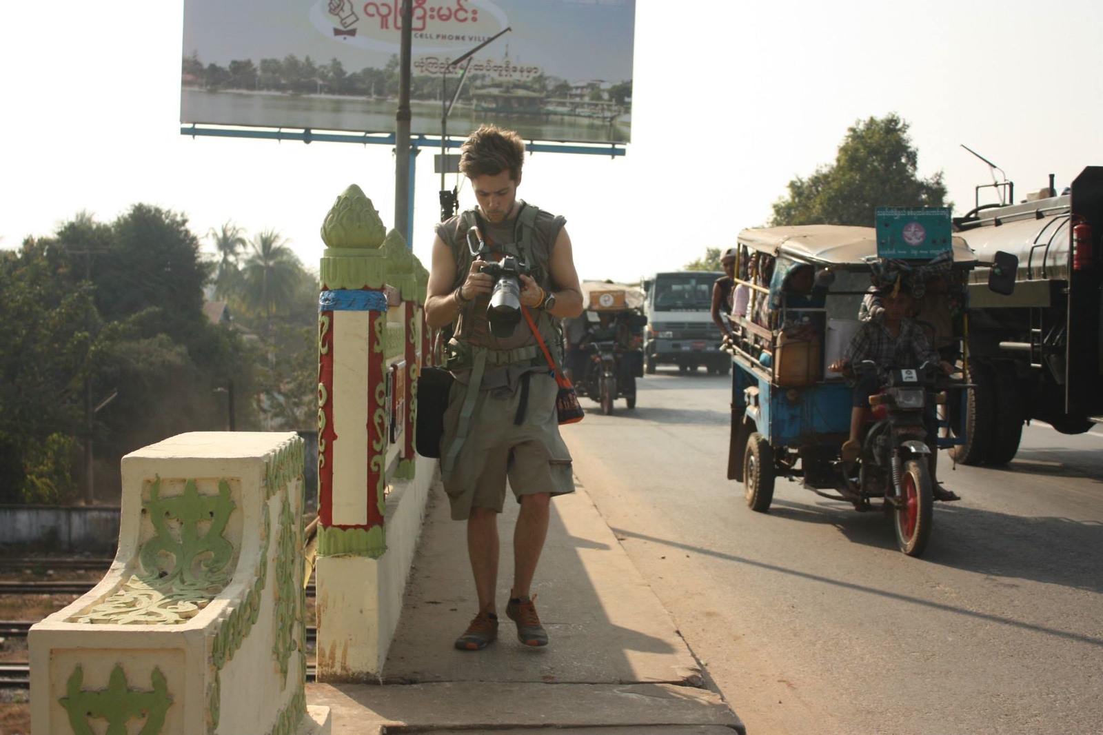 Carter Oswood photographing on a street in Myanmar